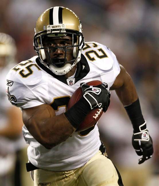 FILE - In this Aug. 12, 2010 file photo, New Orleans Saints' Reggie Bush carries the ball during the first half of an NFL preseason football game against the New England Patriots in Foxborough, Mass. The Miami Dolphins finalized a trade for Bush on Thursday, July 28, 2011, by negotiating a new two-year contract for nearly $10 million with him, a person familiar with the talks said. (AP Photo/Winslow Townson, File).