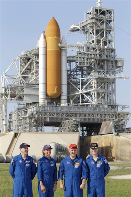 FILE - In this Wednesday, June 22, 2011 file picture, the crew of space shuttle Atlantis, from left, mission specialist Rex Walhiem, mission specialist Sandy Magnus, pilot Doug Hurley and commander Chris Ferguson attend a news conference at Pad 39A during the Terminal Countdown Demonstration Test at the Kennedy Space Center in Cape Canaveral, Fla. The launch of Atlantis, the final space shuttle mission, is scheduled for July 8. (AP Photo/John Raoux).