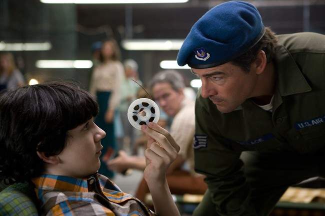 In this film publicity image released by Paramount Pictures, Zack Mills, left, and Kyle Chandler are shown in a scene from "Super 8." The film which takes place in a quiet Ohio industrial town in the first half of 1979. (AP Photo/Paramount Pictures, Francois Duhamel).
