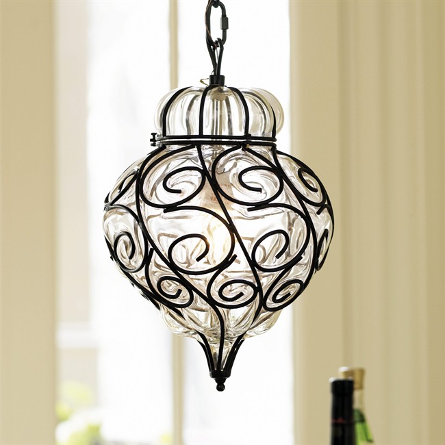 This product image courtesy of Ballard Designs/ballarddesigns.com shows the Marrakesh Onion Bulb pendant lamp. At Ballard Designs, hand-blown glass is encased in wrought iron swirls to create this pendant fixture. (AP Photo/Ballard Designs/ballarddesigns.com ).