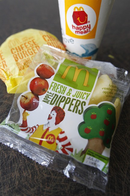 A McDonald's Cheeseburger Happy Meal with the new apple slices option is shown on Tuesday, July 26, 2011, in Pittsburgh. McDonald's Corp. says it is adding apple slices to every Happy Meal, part of the chain's larger push to paint itself as a healthy place to eat. (AP Photo/Keith Srakocic).