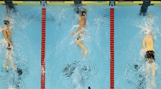 U.S. Ryan Lochte, center, outsprints Michael Phelps, right, and France's Yannick Agnel, to win the gold medal in the men's 200m Freestyle final at the FINA Swimming World Championships in Shanghai, China, Tuesday, July 26, 2011. (AP Photo/Gero Breloer).