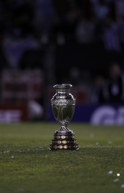 The Copa America trophy sits on the grass after celebrations at the end of the final soccer match in Buenos Aires, Argentina, Sunday, July 24, 2011. Uruguay won the Copa America for a record 15th time after beating Paraguay 3-0 with two goals scored by Diego Forlan and one by Luis Suarez. (AP Photo/Roberto Candia).