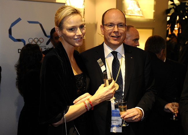 Princess Charlene of Monaco, left, and her new husband Prince Albert of Monaco, pose for a photograph in Durban, South Africa, Tuesday July 5, 2011 before the opening ceremony for the 123rd International Olympic Committee (IOC) session that will decide the host city for the 2018 Olympics Winter Games. IOC President Jacques Rogge will announce Wednesday July 6 2011 which of France's Annecy, Germany's Munich and South Korea's PyeongChang will host the 2018 WInter Olympics. (AP Photo/Stephane de Sakutin, Pool).
