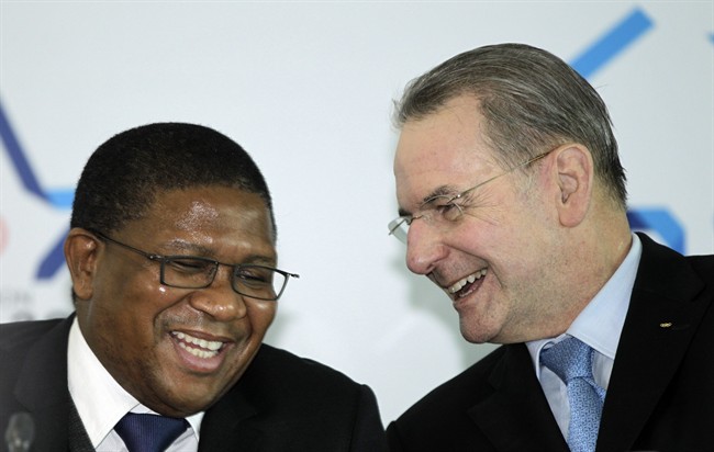 International Olympic Committee President Jacques Rogge, right, shares a light moment with South Africa Sports and Recreation Minister Fikile Mbalula after his arrival at the King Shaka International airport in Durban, South Africa, Monday July 4, 2011. Rogge arrives ahead of the 2018 Winter Olympics announcement on July 6 in Durban. (AP Photo/Themba Hadebe).