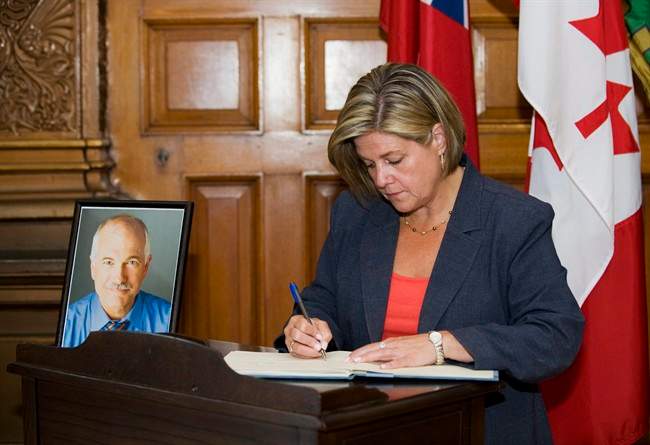 Ontario NDP Leader Andrea Horwath signs a book of condolence for Jack Layton at Queen's Park in Toronto on Thursday August 25, 2011. THE CANADIAN PRESS/Aaron Vincent Elkaim.