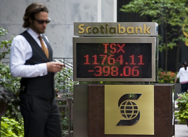 The numbers on the Scotiabank board on King Street in Toronto show the continued tumble of the TSX on Monday morning, August 8 2011. THE CANADIAN PRESS/Aaron Vincent Elkaim.
