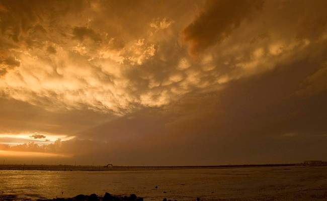 A flooded field is shown after as the remnants of dust and thunder storm past over Queen Creek, Ariz. Thursday, Aug. 18, 2011. (AP Photo/Matt York).
