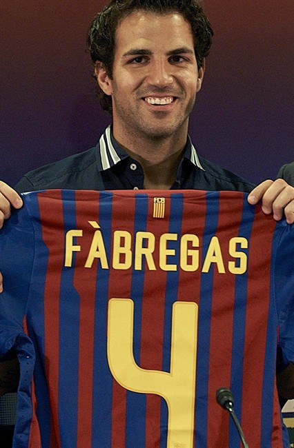 Barcelona's new player Cesc Fabregas holds his jersey during his presentation at Nou Camp stadium in Barcelona, Spain, Monday, Aug. 15, 2011. Fabregas, who come back to his boyhood club after eight seasons with Arsenal, signed a five-year contract Monday. Terms of Fabregas' contract were not announced but Spanish media reported the price tag of the transfer at about euros40 million ($57 million). (AP Photo/Siu Wu).