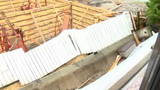 Concrete wall collapses onto neighbouring construction site - image