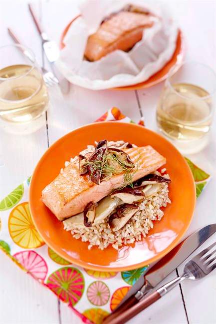 A salmon fillet on bed of brown rice is seen in this undated handout photo. Whether cooked on the barbecue or in the oven, these packets are ideal for summer entertaining and can be prepared in advance, refrigerated and cooked just before serving. THE CANADIAN PRESS/HO.