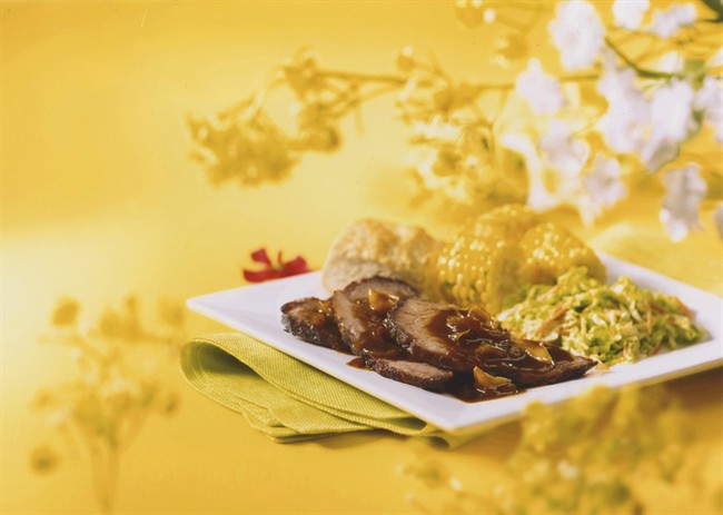 Beef brisket slices with corn on the cob and slaw is seen in this undated handout. THE CANADIAN PRESS/HO.
