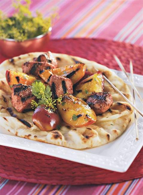 Grilled chicken and peach skewers in a yogurt and tandoori sauce on naan is seen in this undated handout photo. THE CANADIAN PRESS/HO.