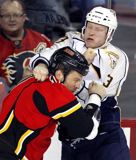 Nashville Predators' Wade Belak, right, fights with Calgary Flames' Brian McGratton during first period NHL hockey action in Calgary, Friday, Jan. 15, 2010. Former NHL enforcer Wade Belak has been found dead. A spokesman with the Nashville Predators confirmed Wednesday night that Belak was found dead in Toronto. THE CANADIAN PRESS/Jeff McIntosh.