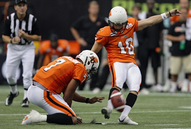 B.C. Lions' Sean Whyte, right, kicks a field goal as Jarious Jackson holds during first half CFL action against the Montreal Alouettes in Vancouver, B.C., on September 4, 2009. Heading into Monday's game in Hamilton, on Sept 5, 2011, Whyte is just six field goals shy of Dave Ridgway's league record of 28 straight. THE CANADIAN PRESS/Darryl Dyck.