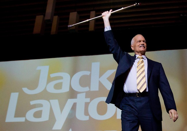 NDP Leader Jack Layton raises his cane as he takes to the stage to deliver his keynote speech to the party's 50th anniversary convention in Vancouver, B.C., on Sunday June 19, 2011. Layton died at his Toronto home this morning at the age of 61. THE CANADIAN PRESS/Darryl Dyck.