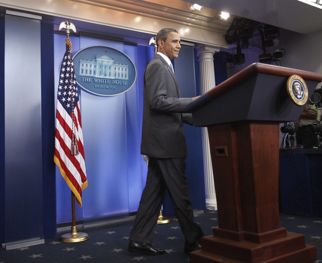 President Barack Obama smiles briefly while approaching the podium to speak in the briefing room at the White House about the debt negotiations in Washington, on Sunday, July 31, 2011. (AP Photo/Jacquelyn Martin).