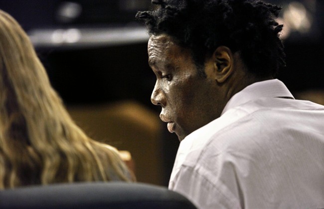 In an Aug. 9, 2011 photo,Futo Charles sits in court during his racketeering trial in West Palm Beach, Fla. Witness Eguel Geffrard, who was scheduled to testify in the trial Monday afternoon, was found murdered in a parking lot Monday morning August 8, 2011 in West Palm Beach. (AP Photo/The Palm Beach Post, Lannis Waters).