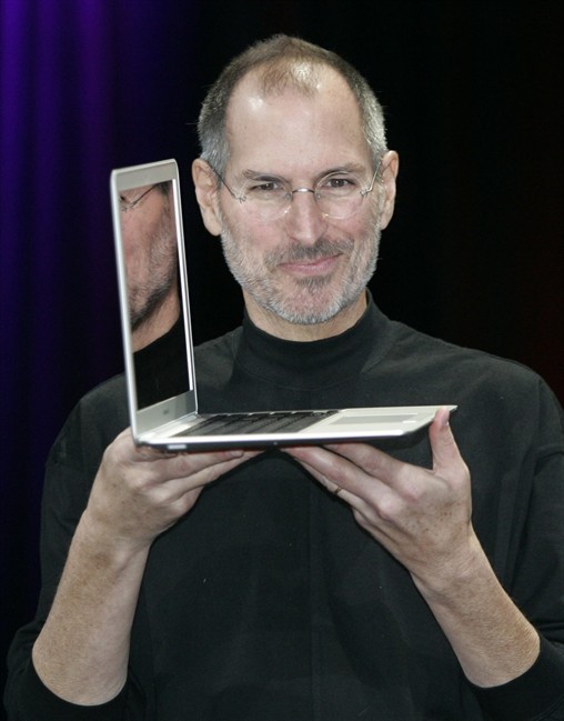 FILE - In this Jan. 15, 2008 file photo, Apple CEO Steve Jobs holds up the MacBook Air after his keynote at the MacWorld Conference in San Francisco. Apple Inc. on Wednesday, Aug. 24, 2011 said Jobs is resigning as CEO, effective immediately. He will be replaced by Tim Cook, who was the company's chief operating officer. It said Jobs has been elected as Apple's chairman. (AP Photo/Paul Sakuma, file).