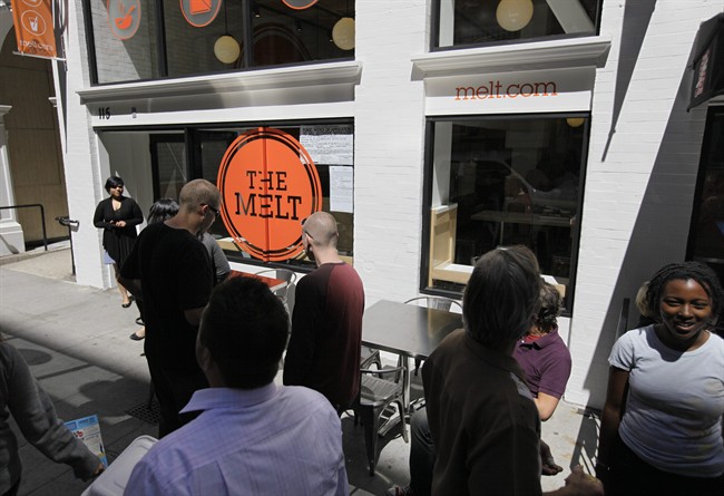 In this photo taken Aug. 25, 2011, a line forms for a sneak preview at The Melt in San Francisco. First, Flip Video camcorder creator Jonathan Kaplan made it easy for consumers to shoot cheesy home movies. Now, he’s hoping to popularize something cheesier and gooier by starting a grilled cheese restaurant business that combines fast food with high tech. The Melt opens its first location Tuesday in San Francisco’s SoMa neighborhood. Kaplan hopes to open 25 to 50 restaurants within the next year, and to have about 500 locations up and running across the country within the next five years. (AP Photo/Eric Risberg).