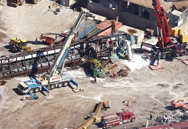 Large cranes are seen at the Sifto salt mine Monday, August 22, 2011, after a tornado ripped through the facility in Goderich, Ontario, Sunday, killing one worker. The family of a salt mine worker killed in a violent tornado that ripped through a southwestern Ontario town on the weekend is raising questions about his death. THE CANADIAN PRESS/Geoff Robins.