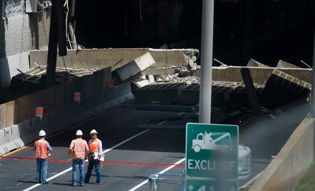 A major downtown Montreal tunnel where huge slabs of concrete fell onto the roadway is expected to reopen to traffic on Saturday. Emergency crews survey the scene after a section of an overpass collapsed in downtown Montreal, Sunday, July 31, 2011.THE CANADIAN PRESS/Graham Hughes.
