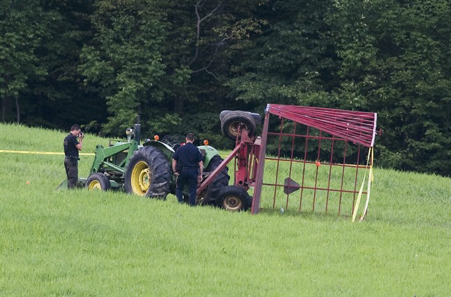 Police examine the scene in Bromptonville, Que., Wednesday, August 3, 2011, where a tractor trailer overturned resulting in the injuries to over twenty children. THE CANADIAN PRESS/Graham Hughes.
