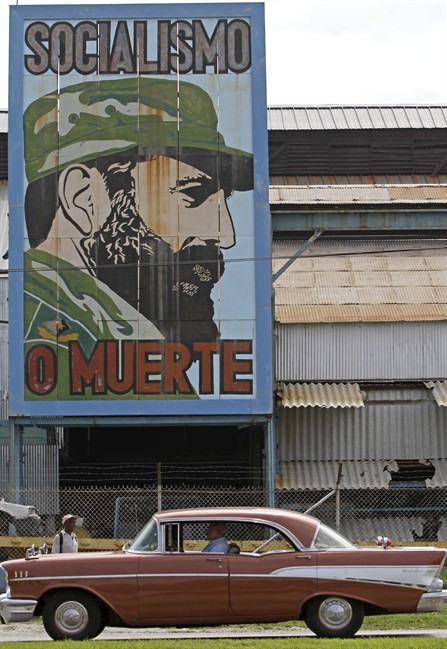 A car drives past a billboard showing Cuban leader Fidel Castro with the words reading in Spanish ‘Socialism or death’, in Havana, Cuba, Friday, Aug.12, 2011. Artists and admirers of ailing Fidel Castro celebrate his 85th birthday starting today with different events. Castro will turn 85 Saturday. (AP Photo/Franklin Reyes)