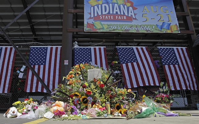 A patron stops and views a memorial in front of the Grandstand at the Indiana State Fair in Indianapolis, Wednesday, Aug. 17, 2011. The memorial is set-up for those who were killed when a stage collapsed Saturday night. After high winds toppled a huge outdoor stage, killing five people and injuring at least four dozen, questions about whether the fair did enough to anticipate a storm have loomed over the event. (AP Photo/Darron Cummings).