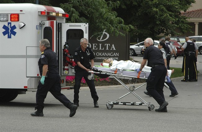 FILE. Paramedics take one of several victims of a shooting outside of the Delta Grand hotel in downtown Kelowna, B.C., to hospital on Sunday, April 14, 2011. 