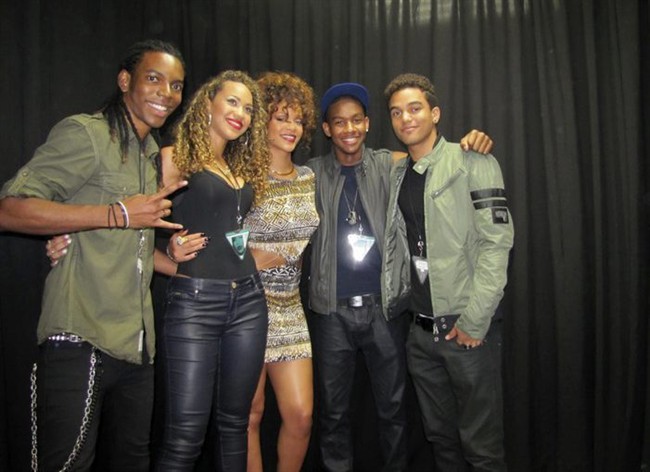 In this Aug. 5, 2011 image made available by wearecoverdrive.com Rihanna poses for a photograph with her supporting act Cover Drive, from left, Barry Hill, Amanda Reifer, Rihanna, T. Ray Armstrong and Jamar Harding backstage at Kensington Oval, near Bridgetown, Barbados. Rihanna's not just sitting pretty, enjoying her mega-successful career _ she's also lending a helping hand to other musical acts from Barbados. She picked newcomers Cover Drive to back her at an Aug. 5 show for 20,000 in her homeland, which ensured strong notice for the newcomers. (AP Photo/wearecoverdrive.com) EDITORIAL USE ONLY.