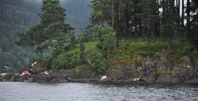 FILE - In this photo taken by Vergard M. Aas, a Norwegian crime reporter who responded to the scene of a mass shooting on Utoya Island, Norway, victims lie near the shoreline approximately one hour after police say a man dressed as a police officer gunned down youths as they ran and even swam for their lives at a camp which was organized by the youth wing of the ruling Labor Party, Friday July 22, 2011. Norwegian police say the man who has confessed to killing 69 people at an island youth camp has been brought back to the crime scene. Police say they took Anders Behring Breivik back to Utoya island on Saturday for a reconstruction of the July 22 terror attacks, when Breivik shot the victims dead on the island and killed eight further people in central Oslo with a bomb. (AP Photo/Presse 3.0, Vegard M. Aas, File) NORWAY OUT MANDATORY CREDIT.