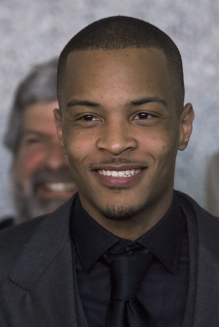 FILE - In this Friday, March 27, 2009 file photo, Rapper T.I., born Clifford Harris Jr., speaks to reporters after being sentenced to one year and one day on federal weapons charges at the Federal Courthouse in Atlanta. Bureau of Prisons spokesman Chris Burke said the rapper, T.I., whose real name is Clifford Harris, was released Wednesday, Aug. 31, 2011 from the Forrest City low-security prison in Arkansas. The rapper was sentenced to 11 months in prison in October for breaking his federal probation after he was arrested in Los Angeles on drug charges. He was set to be released at the end of September, but prison authorities released him a month early. (AP Photo/John Amis, File).