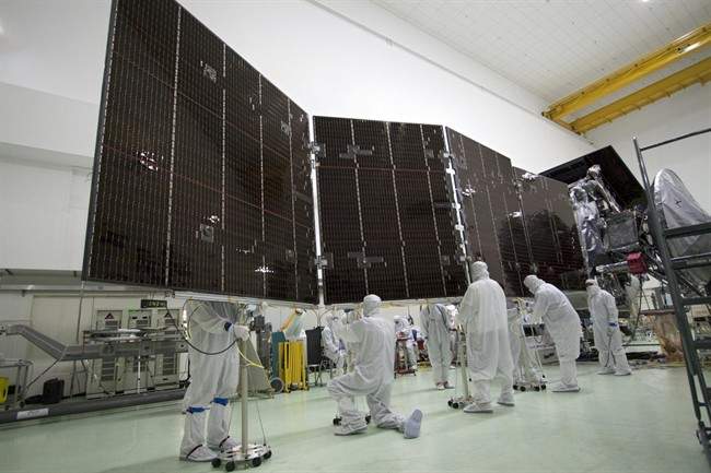 In this May 27, 2011 photo made available by NASA, technicians at Astrotech's payload processing facility in Titusville, Fla., stow solar array #2 against the body of NASA's Juno spacecraft. The robotic explorer Juno is set to become the most distant probe ever powered by the sun. Launch is set for Friday, Aug. 5, 2011, aboard an unmanned Atlas V rocket _ barely two weeks after NASA's final space shuttle flight. ??(AP Photo/NASA/JPL-Caltech/KSC).