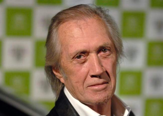 FILE - In this Wednesday, Nov. 8, 2006 file photo, actor David Carradine arrives for the 16th annual Environmental Media Awards in Los Angeles. Court records in Los Angeles show that Carradine's widow, Anne, has settled a wrongful death lawsuit against a French company that was handling the actor's final film. Carradine was found dead in June 2009 in a Bangkok hotel room. (AP Photo/Phil McCarten, file).