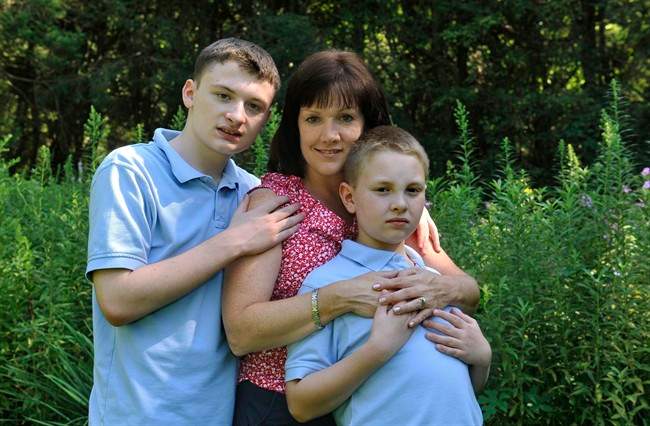 Kathleen Lanese of Kings Park, N.Y., with her two autistic sons Brendan, 14, left and Kevin, 10 at her sister-in-law's home on Thursday, Aug. 11, 2011, in Oyster Bay, N.Y. Lanese says having one son with autism didn't make her think twice about trying to have another child, even though she knew there was a chance the second would be affected, too. (AP Photo/Kathy Kmonicek).