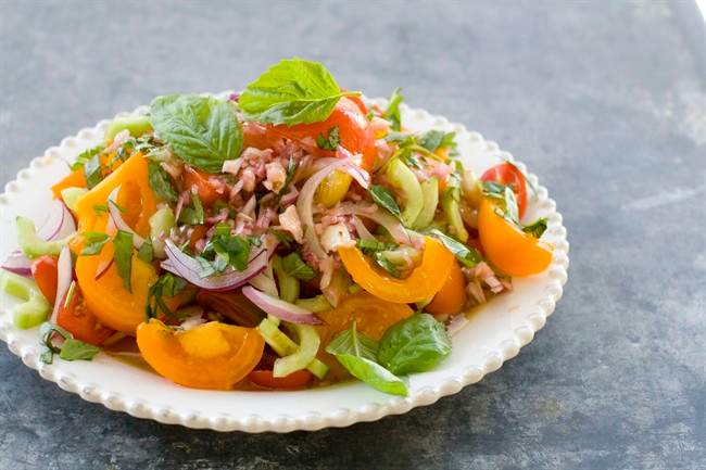 This Aug. 1, 2011 photo shows heirloom and cherry tomato salad in Concord, N.H. For the AP’s 20 Salads of Summer series, Alice Waters offered this recipe for a simple but stunning salad. (AP Photo/Matthew Mead).