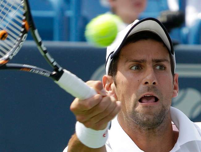 Novak Djokovic, from Serbia, hits a forehand during the men's final against Andy Murray, of Britain, at the Western & Southern Open tennis tournament, Sunday, Aug. 21, 2011, in Mason, Ohio. Djokovic retired with a shoulder injury and Murray leading 6-4, 3-0. (AP Photo/Al Behrman).