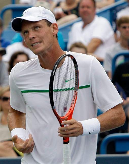 Tomas Berdych, from the Czech Republic, grimaces during a semifinal match against Novak Djokovic, from Serbia, at the Western & Southern Open tennis tournament, Saturday, Aug. 20, 2011 in Mason, Ohio. Berdych retired with an injury to his right shoulder and Djokovic leading 7-5. (AP Photo/Al Behrman).