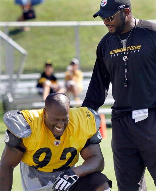 Pittsburgh Steelers linebacker James Harrison (92) laughs with coach Mike Tomlin during training camp at the NFL football team's practice facility in Latrobe, Pa., on Sunday, July 31, 2011. (AP Photo/Keith Srakocic).