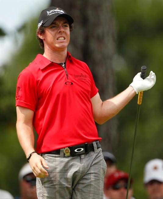 Rory McIlroy, of Northern Ireland, grimaces after hitting a drive on the eighth tee during the first round of the PGA Championship golf tournament Thursday, Aug. 11, 2011, at the Atlanta Athletic Club in Johns Creek, Ga. McLLroy injured his wrist on the third hole when is club struck a tree root. (AP Photo/Charlie Krupa).