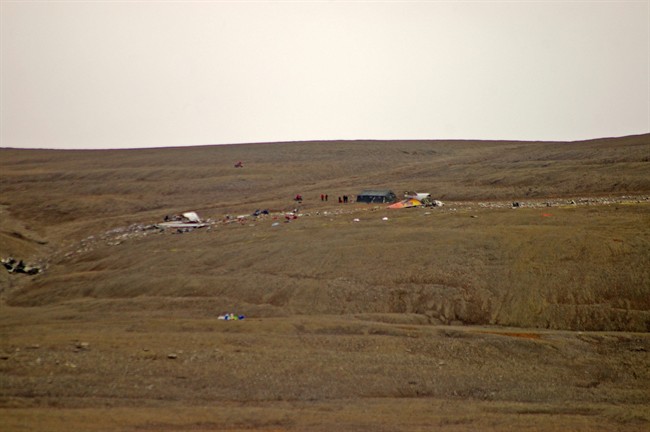 Canadian Rangers (in red) and investigators work at the scene of the First Air crash site in Resolute Bay, Nunavut on Sunday Aug. 21, 2011. THE CANADIAN PRESS/Nicolas Laffont.