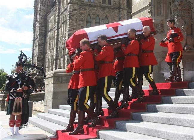 The coffin of Jack Layton is carried from Parliament Hill in Ottawa on Thursday, Aug. 25, 2011 after lying in state for two days. The coffin will make its way to Toronto for a state funeral on Saturday. THE CANADIAN PRESS/Ryan Remiorz.