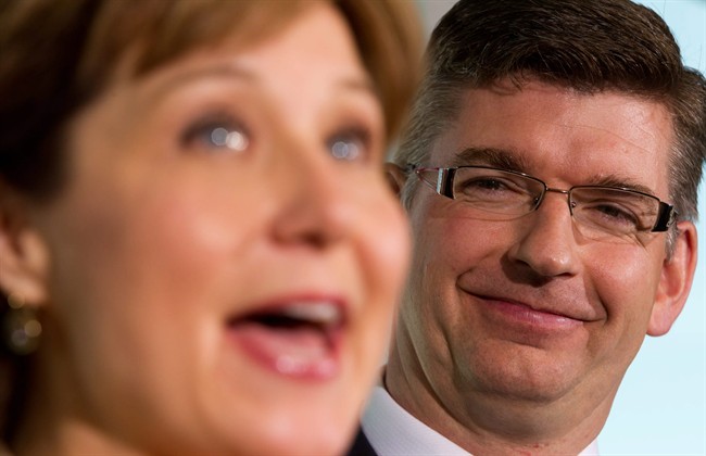 British Columbia MLA Iain Black, right, smiles as B.C. Premier Christy Clark speaks after Black announced he was stepping down as an MLA in Vancouver, B.C., on Wednesday August 24, 2011. Black is leaving politics to become the CEO of the Vancouver Board of Trade. THE CANADIAN PRESS/Darryl Dyck.