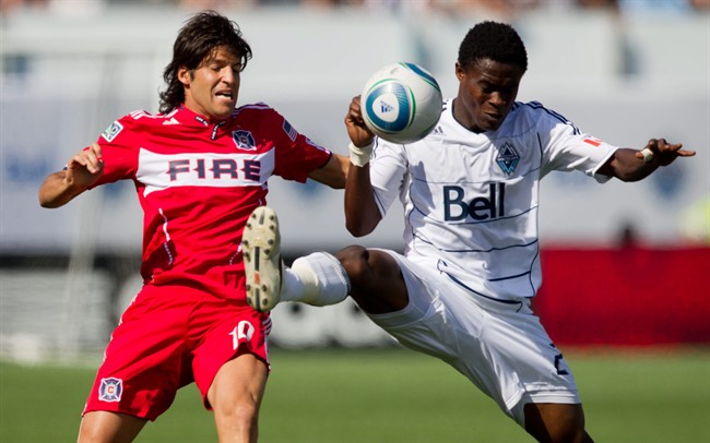 Chicago Fire's Sebastian Grazzini, left, and Vancouver Whitecaps' Gershon Koffie battle for the ball during the first half of an MLS soccer game in Vancouver, B.C., on Sunday August 7, 2011. THE CANADIAN PRESS/Darryl Dyck.