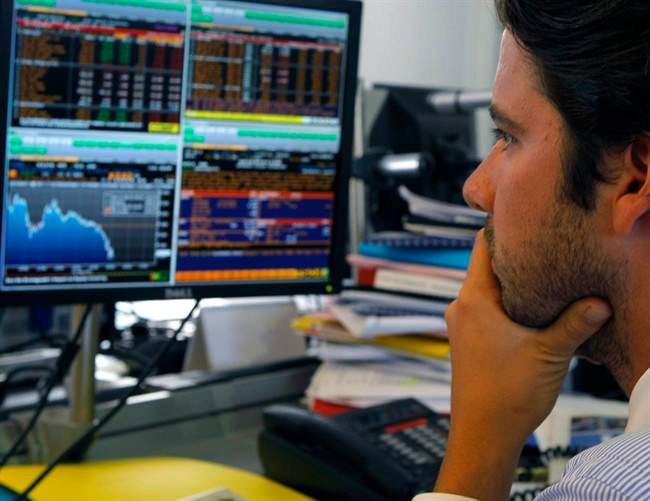 A broker works in a trading room in Paris, Wednesday, Aug. 10, 2011. Worries over the debt problems afflicting a number of European countries as well as the U.S. have knocked confidence over the global economic recovery and triggered turmoil in financial markets around the world.(AP Photo/Jacques Brinon).