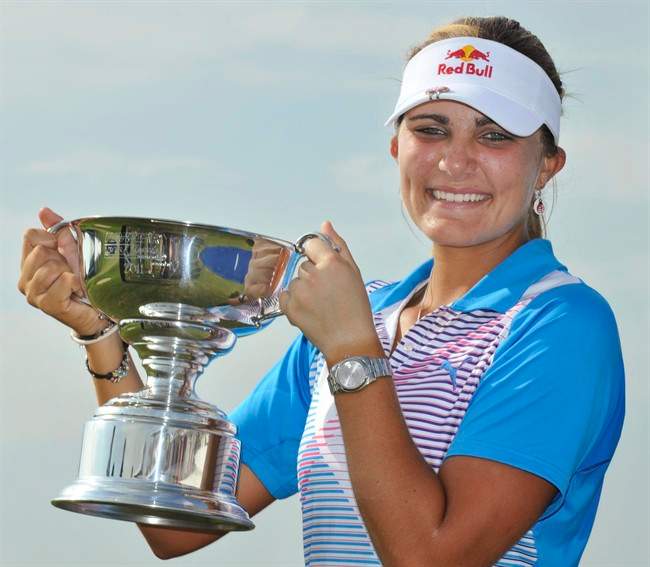Lexi Thompson holds high her trophy after winning the Navistar LPGA Classic on the Robert Trent Jones Golf Trail at Capitol Hill in Prattville, Ala., on Sunday Sept. 18, 2011. (AP Photo/Montgomery Advertiser, Lloyd Gallman).