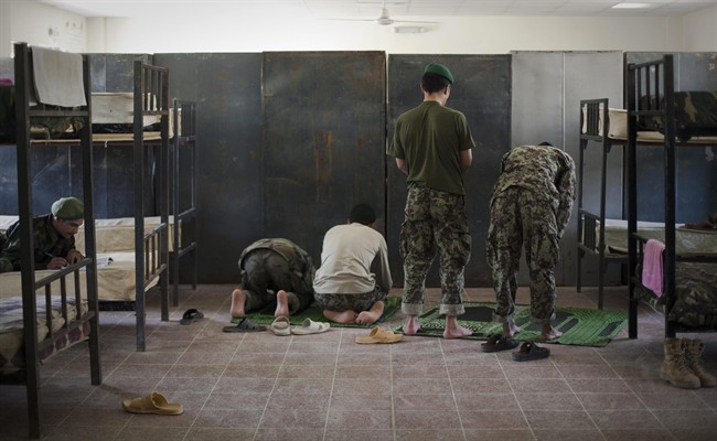 Afghan National Army soldiers pray inside their sleeping quarters at their barracks in Kunduz, northen Afghanistan, Sunday,Sept. 25, 2011. (AP Photo/Anja Niedringhaus).