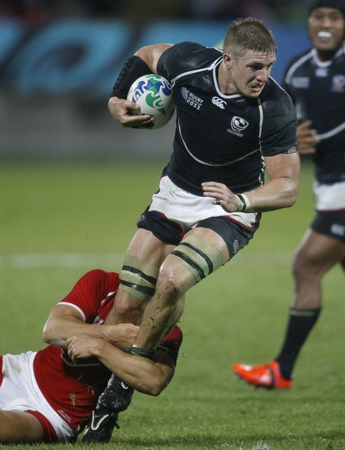 Louis Stanfill of the USA is tackeld by Russia's Yury Kushnarev during their Rugby World Cup game in New Plymouth, New Zealand, Thursday, Sept. 15, 2011. (AP Photo/Dita Alangkara).