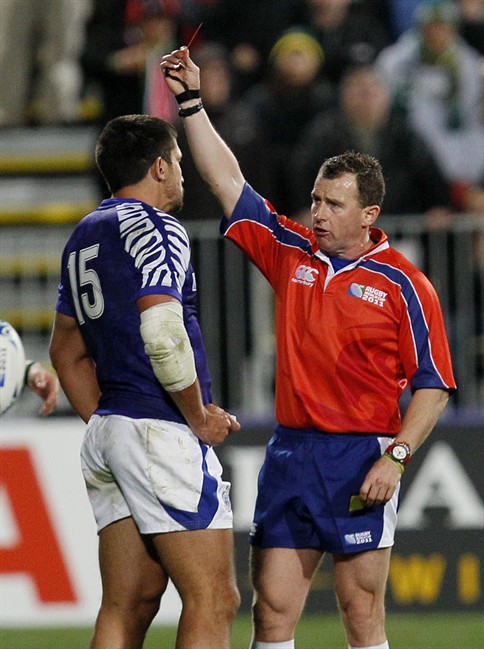 Referee Nigel Owens, right, shows the red card to Samoa's Paul Williams after he struck South Africa's Heinrich Brussow during their Rugby World Cup game at North Harbour stadium in Auckland, New Zealand, Friday, Sept. 30, 2011. (AP Photo/Alastair Grant).